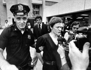 (NYT204) NEW YORK -- Aug. 12, 2002 -- 9-11-WTC-4 -- French high-wire artist Philippe Petit, center, is escorted from a downtown hospital where he was taken for evaluation following his arrest after walking a tightrope across the World Trade Center in 1974. He was released shortly thereafter. The twin towers were despised in some quarters as an overscaled boondoggle when construction began in 1973. What turned the tide of public regard was not the bigness of the place but the way it could be momentarily captured by fanciful gestures on a human scale. (Neal Boenzi/The New York Times)